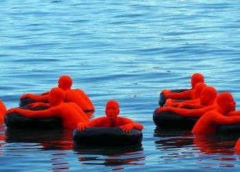 Toronto: SOS by Ann Hirsch & Jeremy Angier - 25 figures cling to inner tubes on the water, each figure represents more than one million refugees in the world