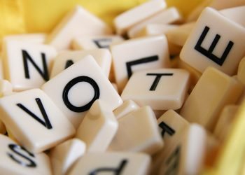 Scrabble tiles spelling ‘VOTE’