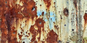 How can this be? Rusted bullet holes in a metal door