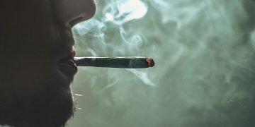 Decriminalisation of drugs: profile of a man smoking cannabis