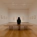 Arts, culture, and heritage: woman sitting in a gallery with empty frames