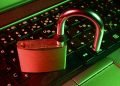 An open padlock sitting on a keyboard in red and green tones