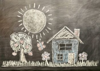 Education system: a child’s chalkboard drawing of a house, tree, sun, butterfly, and flowers